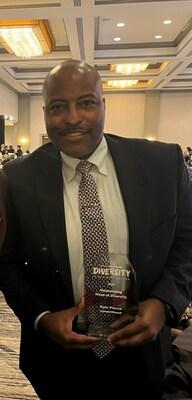 Kyle Pierce holding his award from the Houston Business Journal's 2023 Head of Diversity Awards