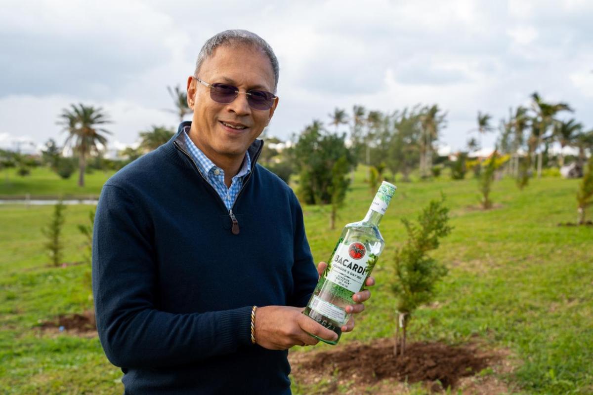 new trees with the CEO holding a bottle of bacardi