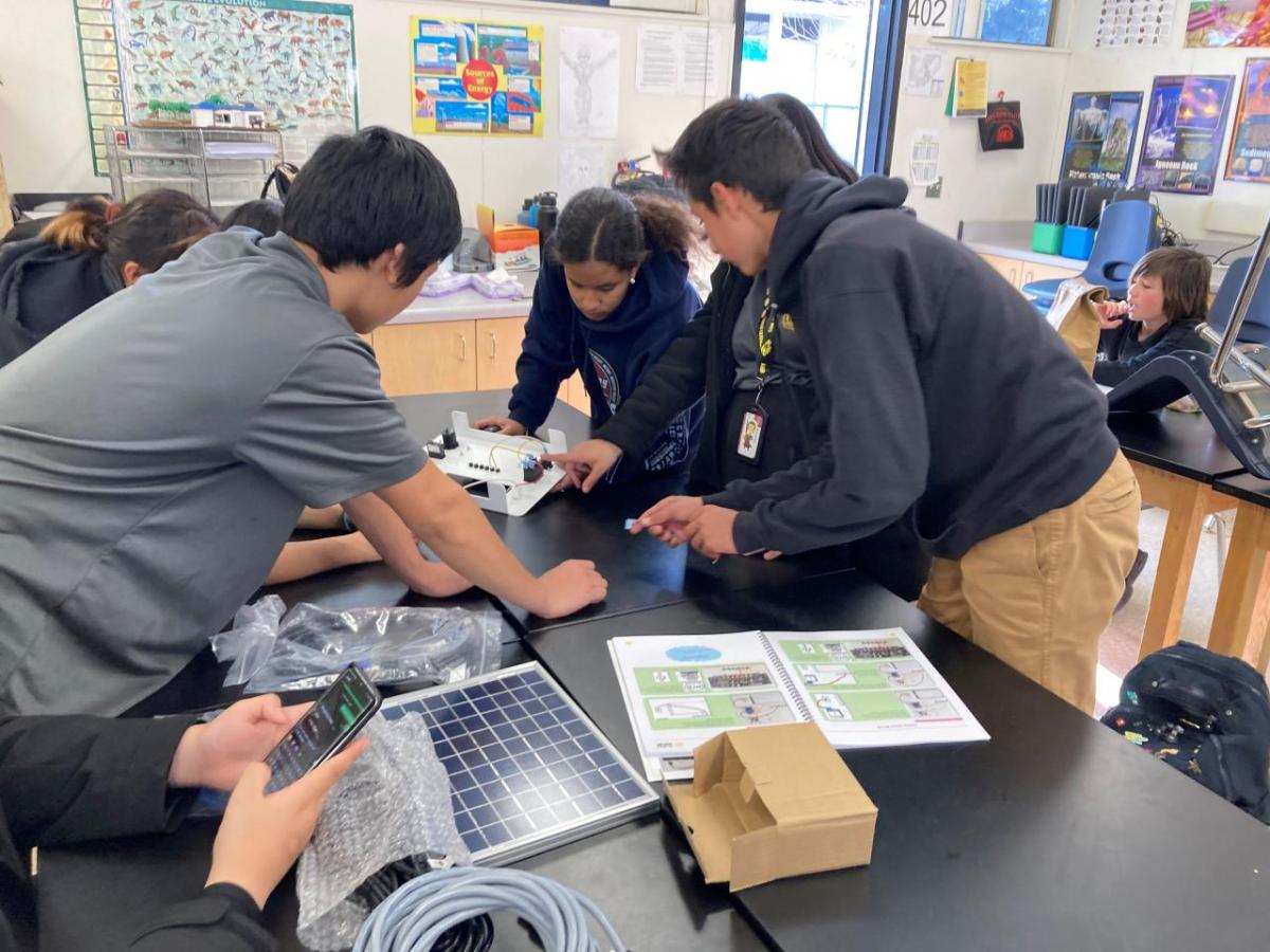 A team of students working on solar battery kit.