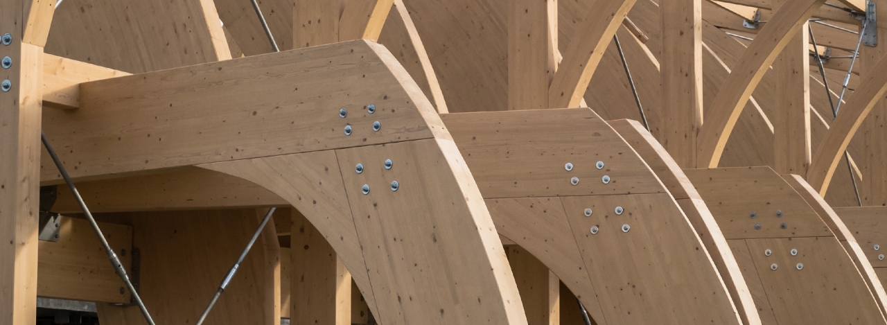 row of wood beams and rivets