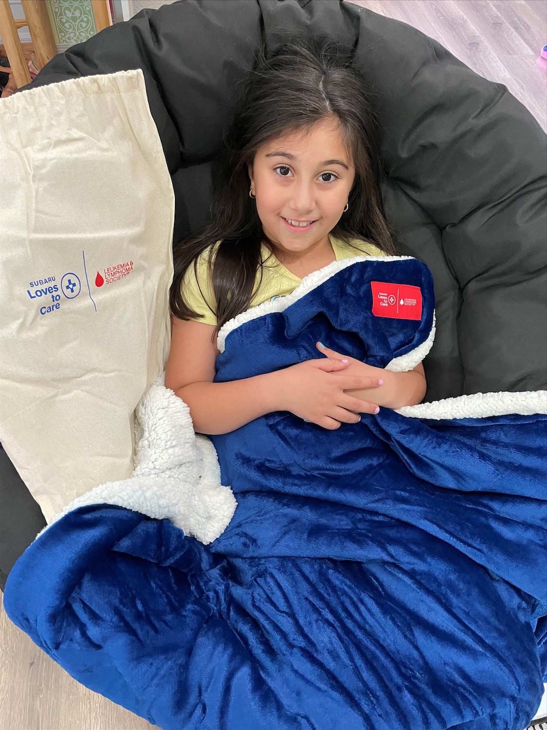 child cancer patient receives blanket in a hospital