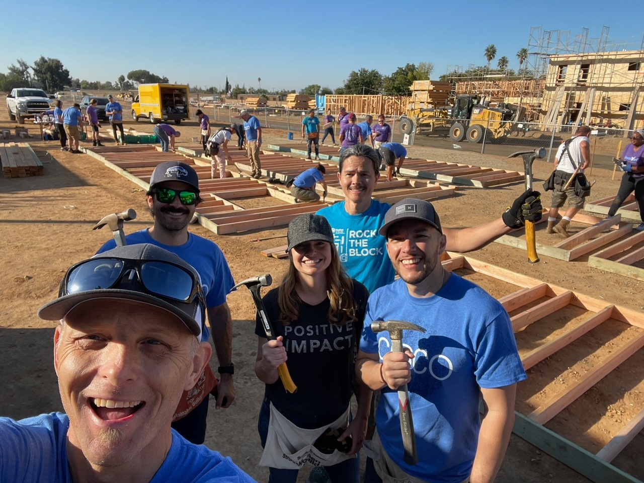 Posing for a selfie in front of the construction of a home