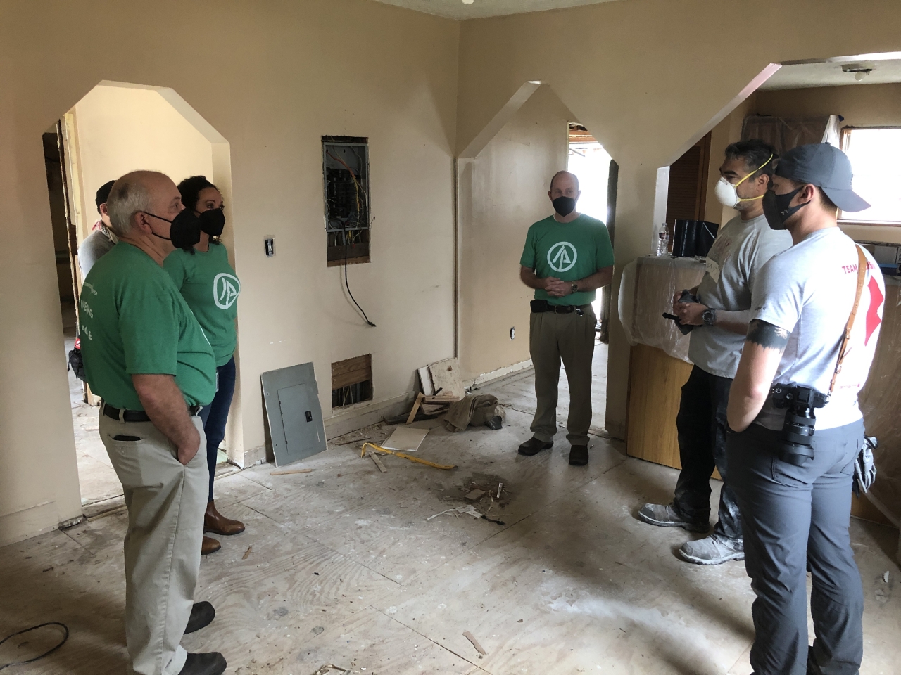 team of volunteers in a damaged home