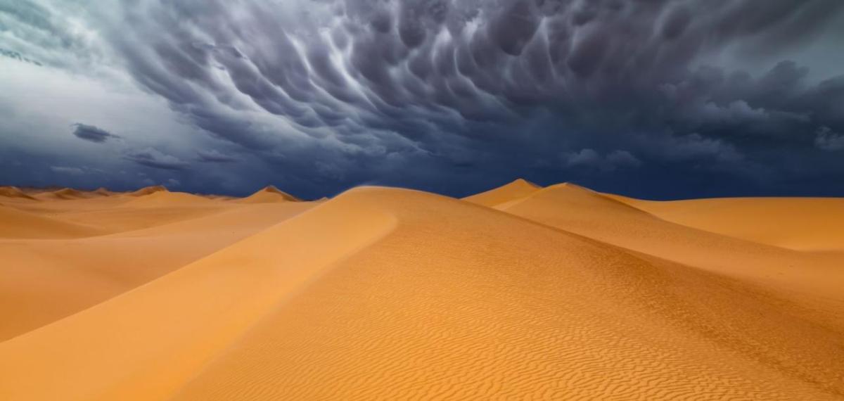 Sand dunes with stormy sky