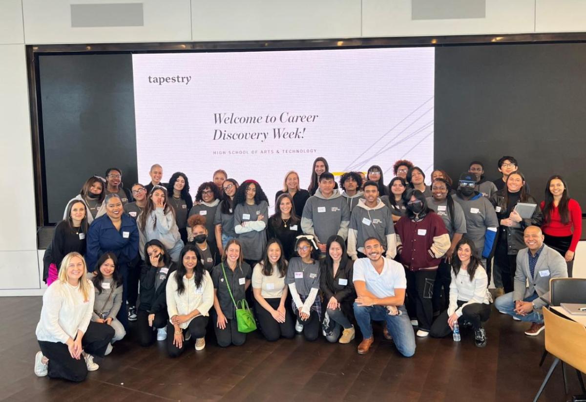 A large group of people posed in front of a large digital display "Welcome to Career Discovery Week!"