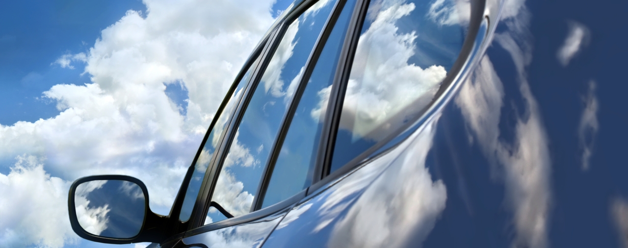 car with blue sky and clouds