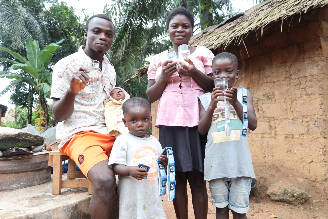 Carrine and her family with safe drinking water