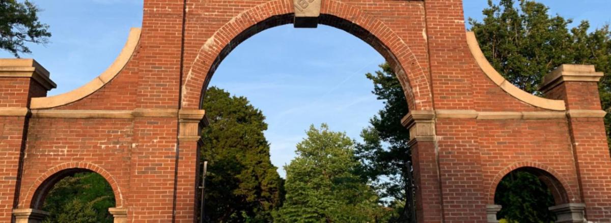 A tall brick archway entrance to the cemetary.