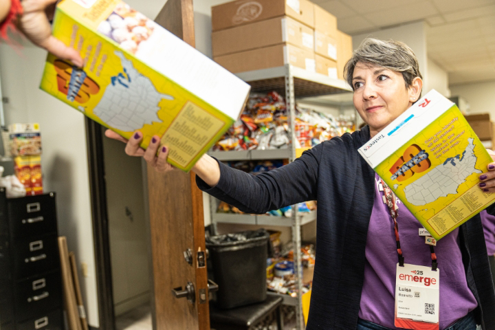 Woman handing cereal boxes to someone