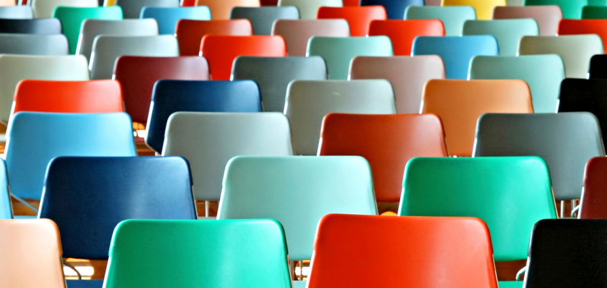 Rows of colorful empty chairs.