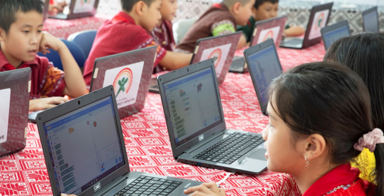 class of students on laptops