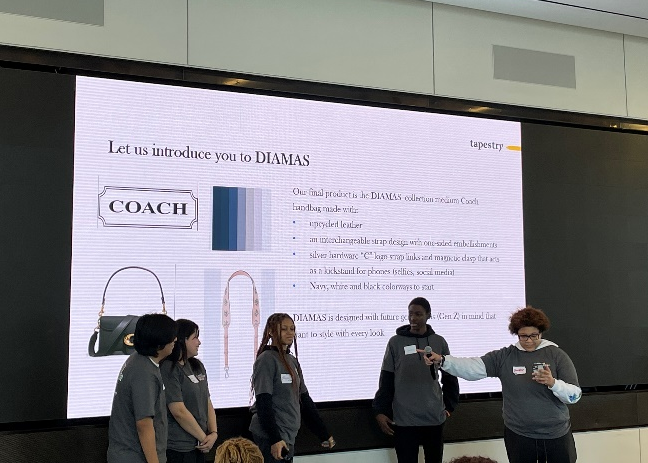 Five people at the front of an audience, one pointing to another. A digital display "Let us introduce you to DIAMAS". Coach logo, purse, handle, and color swatches.