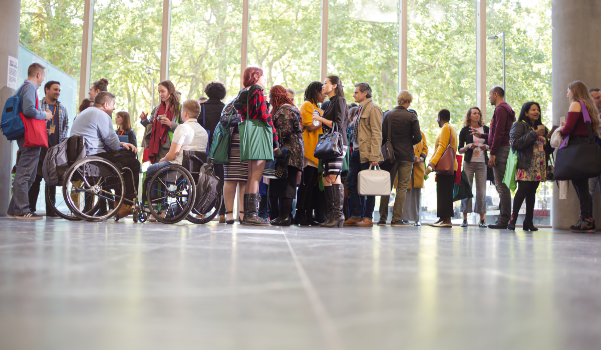 group of people standing together in a large room