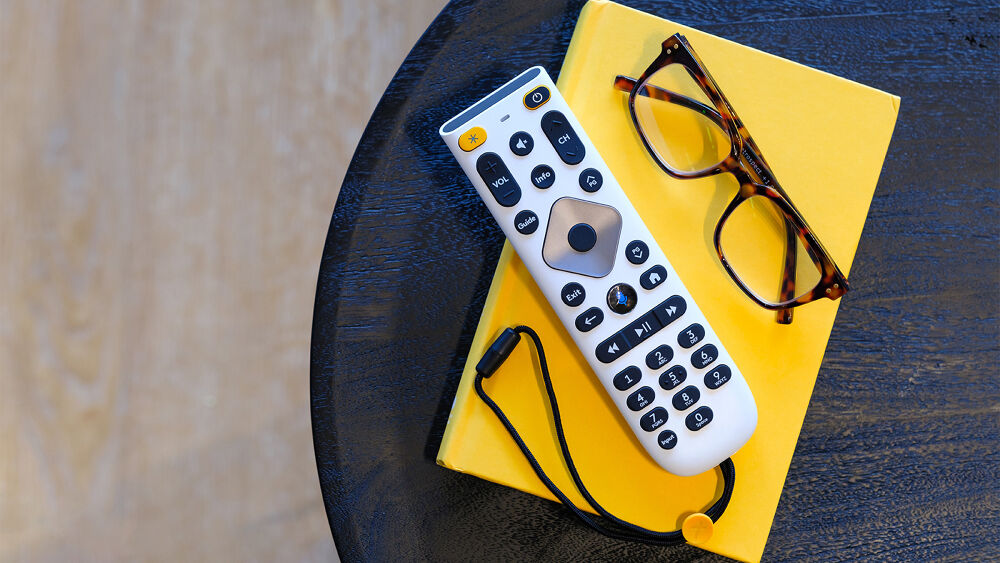 large button remote and glasses on a coffee table