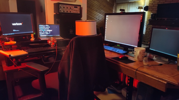 Desk with four monitors on