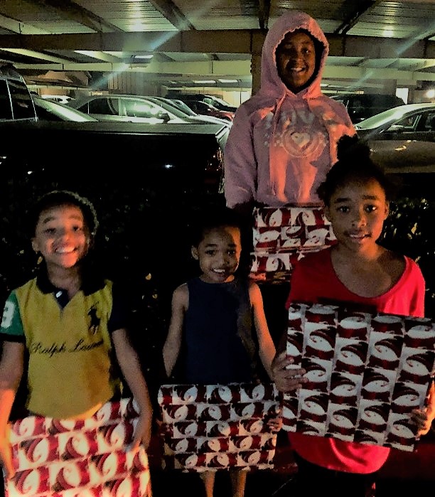 The Williams family, ages 6 to 13 receiving C2K laptops for Christmas to help them with their studies at Silver Wing Elementary School and Montgomery Middle School in San Diego.