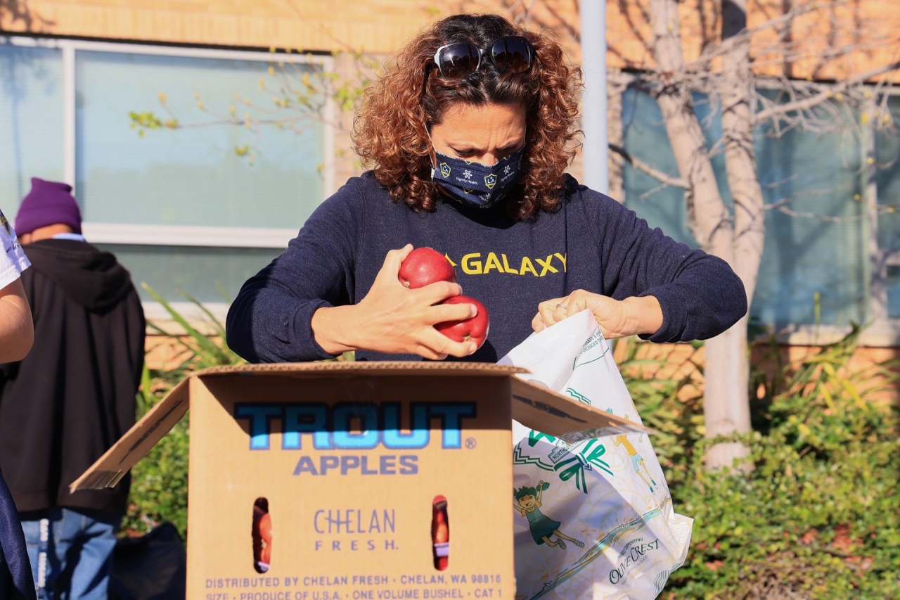 LA Galaxy volunteers pack grocery bags to help more than 350 vulnerable students during LA Harbor College's Spring Food Distribution event