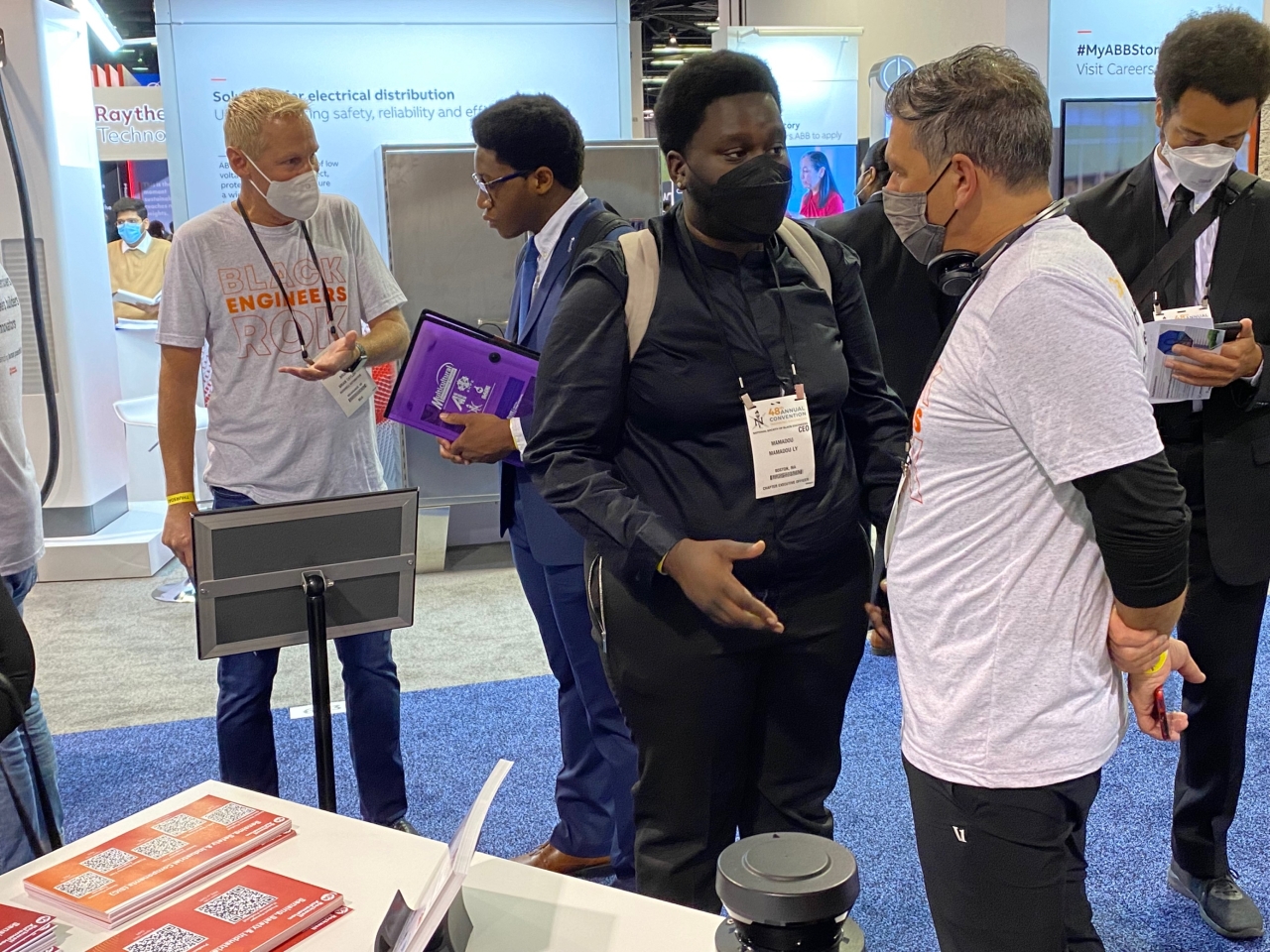 Rockwell’s Brian Taylor (far left) and Chris Nardecchia (far right), senior vice president and Chief Information and Digital Officer, meet with NSBE attendees.