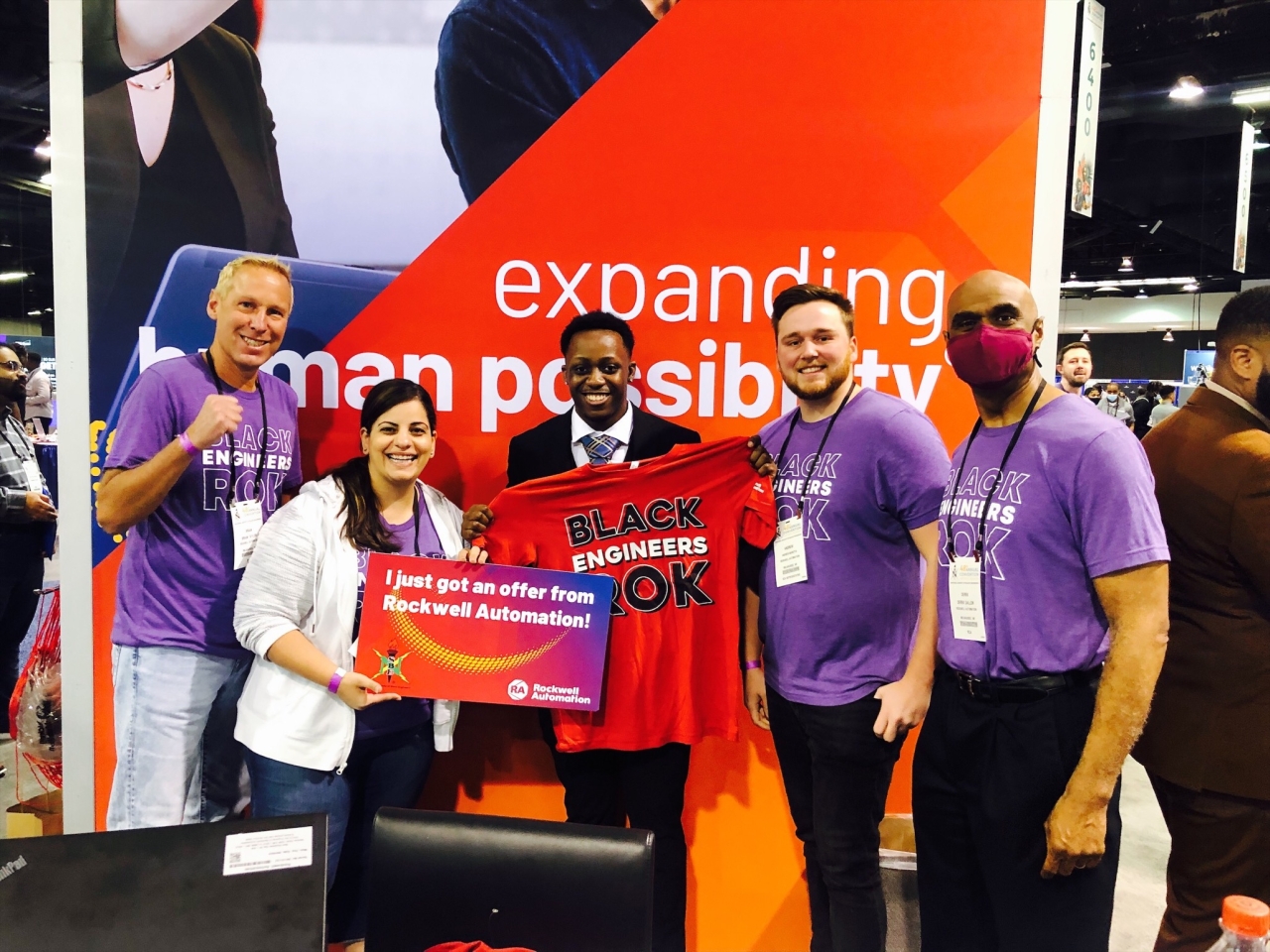 NSBE attendee Rasheed Martin (center) celebrates his offer with (from left to right) Rockwell’s Brian Taylor, Sabha Museteif, Andrew Marotta, and Derek Gallon.