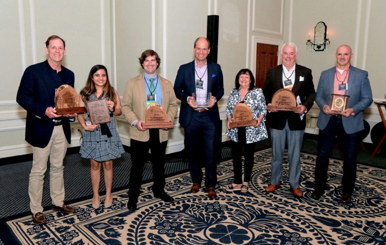 7 people holding awards