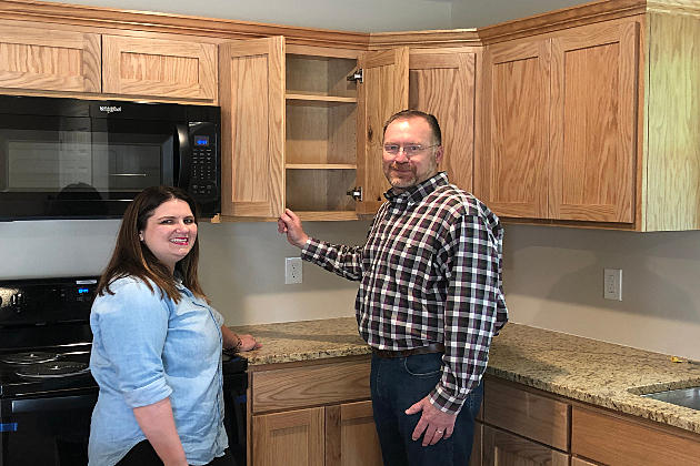 2 people standing in their new home