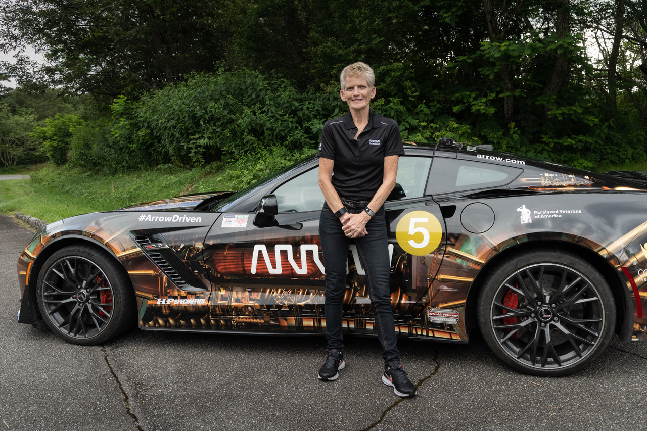 Gretchen Evans standing in front of Arrow SAM car