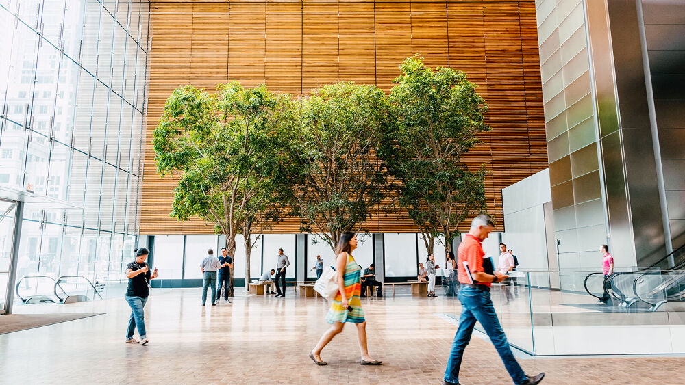 People walking around the lobby of a big building