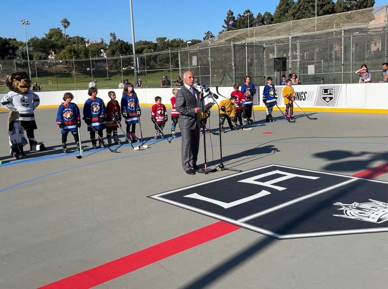 LA Kings radio analyst Daryl Evans emcees the ribbon cutting ceremony to commemorate the newly completed roller hockey rink in El Segundo on August 26, 2021.