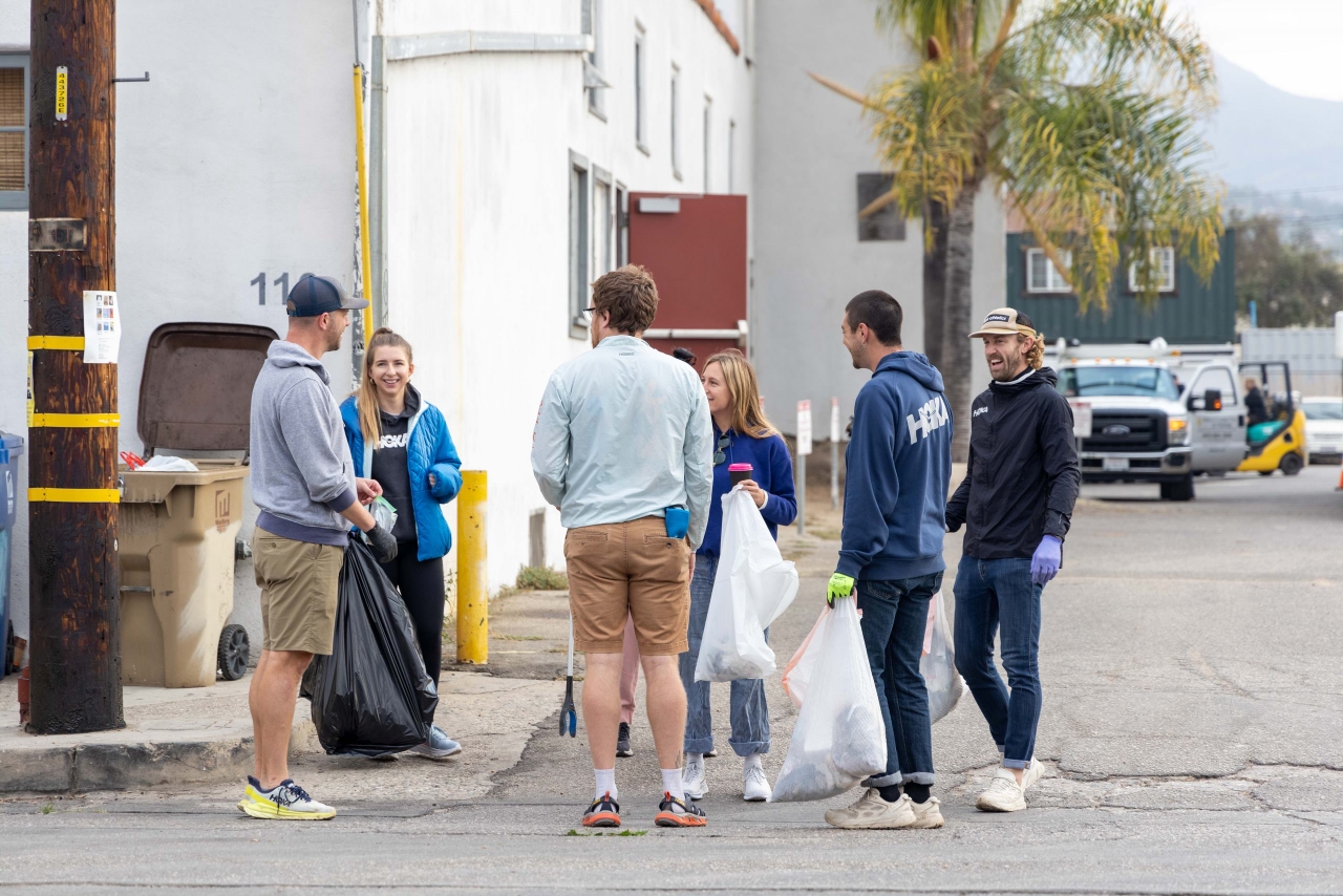 A group of volunteers gather trash in the streets