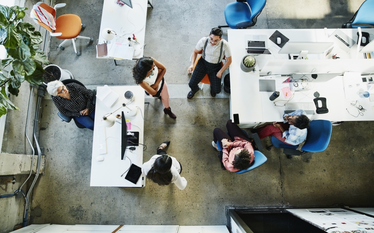 top down view of 6 employees working in an office