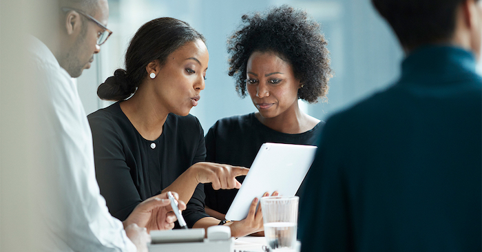 Two people looking at a smart tablet together