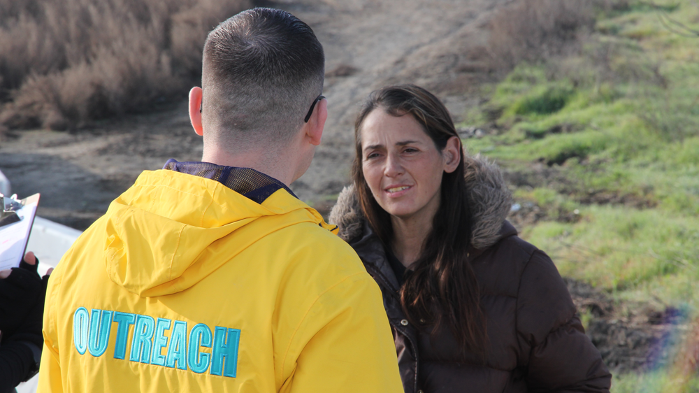 Outreach person talking to a homeless person