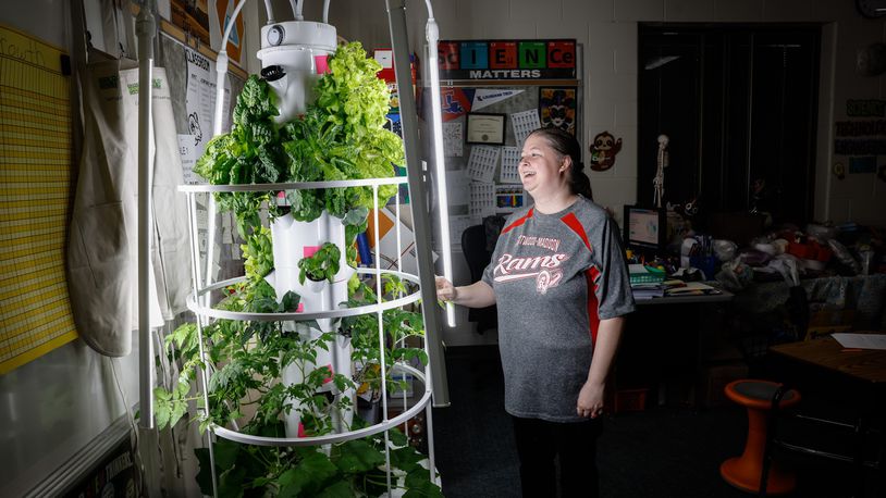 person with indoor garden