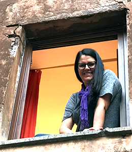Shawna leaning out the window in Italy