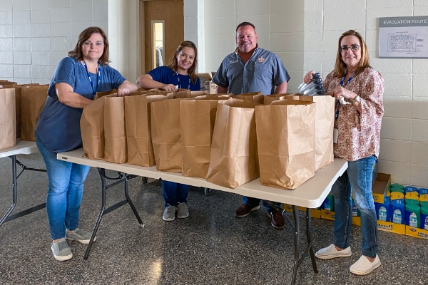 volunteers with bags of food