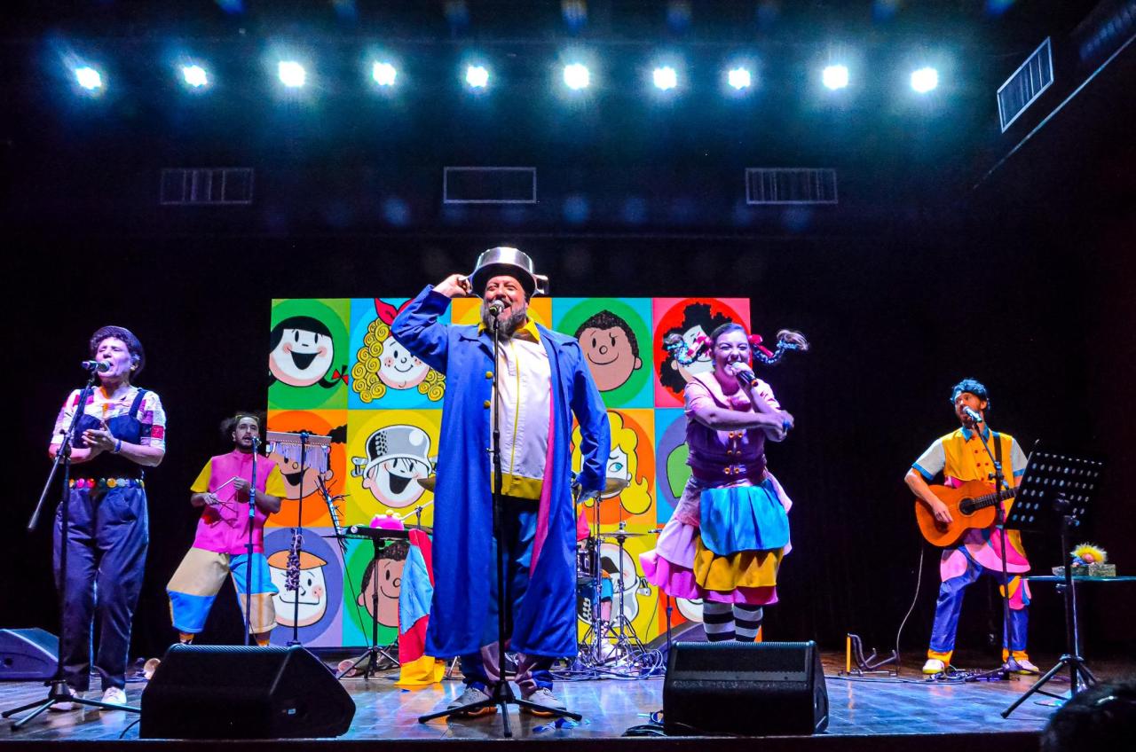 People in brightly colored clothing performing on a stage