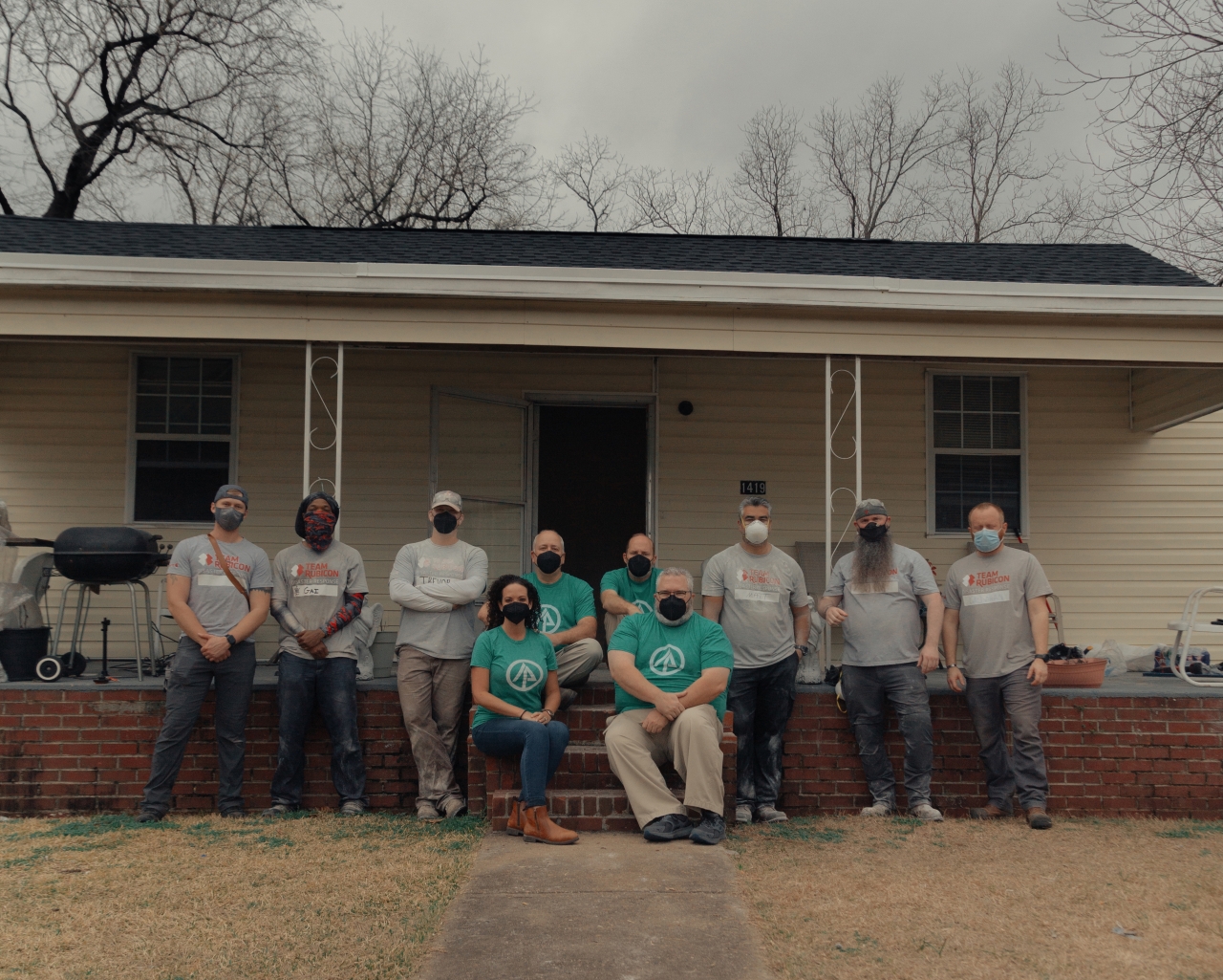 volunteers in front of home