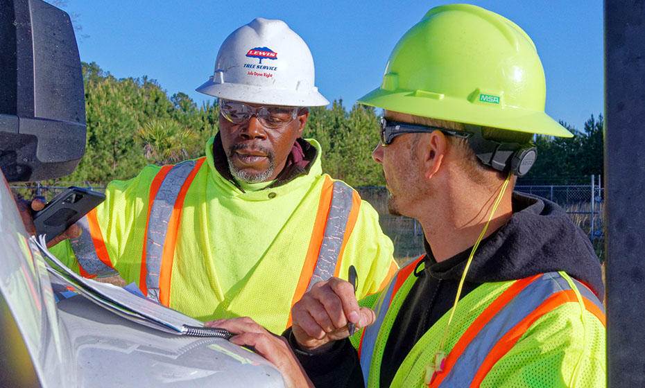 Lacardo Davis, left, and Joey Hunt start their day at a job site in Sumter, S.C., going over safety regulations. 