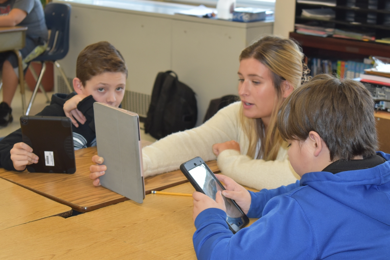 teacher and students on devices