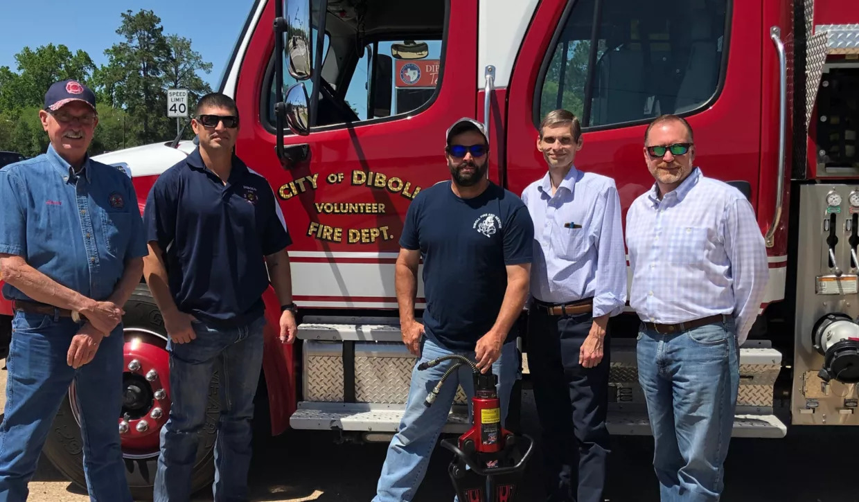 volunteer firefighters, the mayor of diboll and Georgia Pacific rep standing by a fire truck