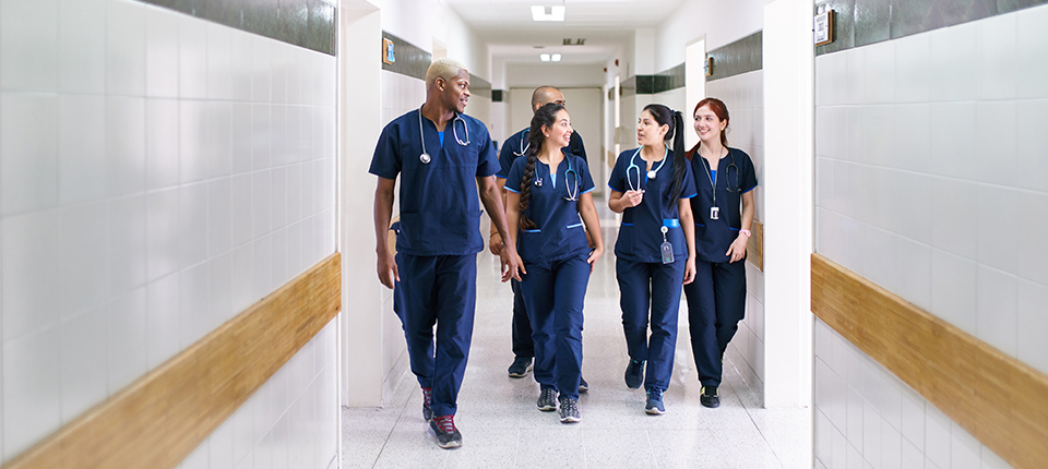 doctors walking in a white hallway
