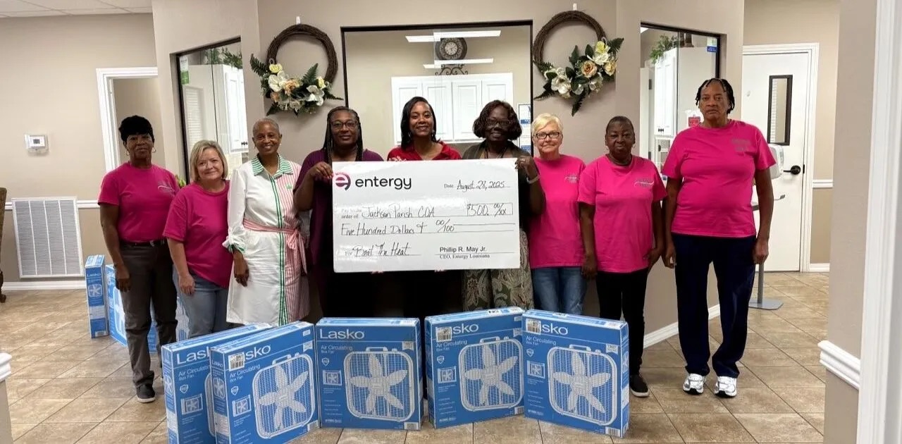 people with window fans and a donation