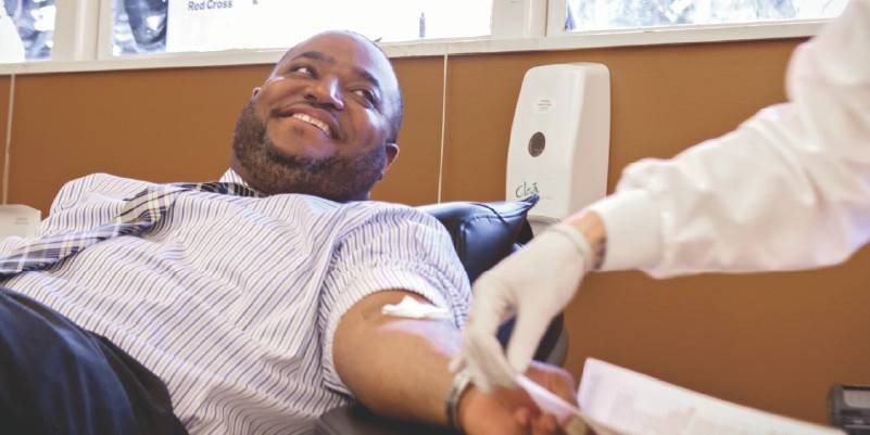 a person laying down, donating blood