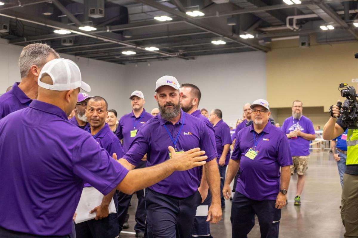 team of fedex drivers congratulating each other