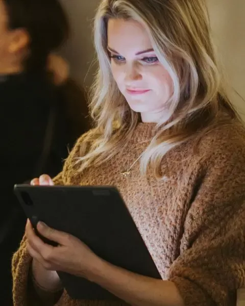 Catherine Capon using a tablet.