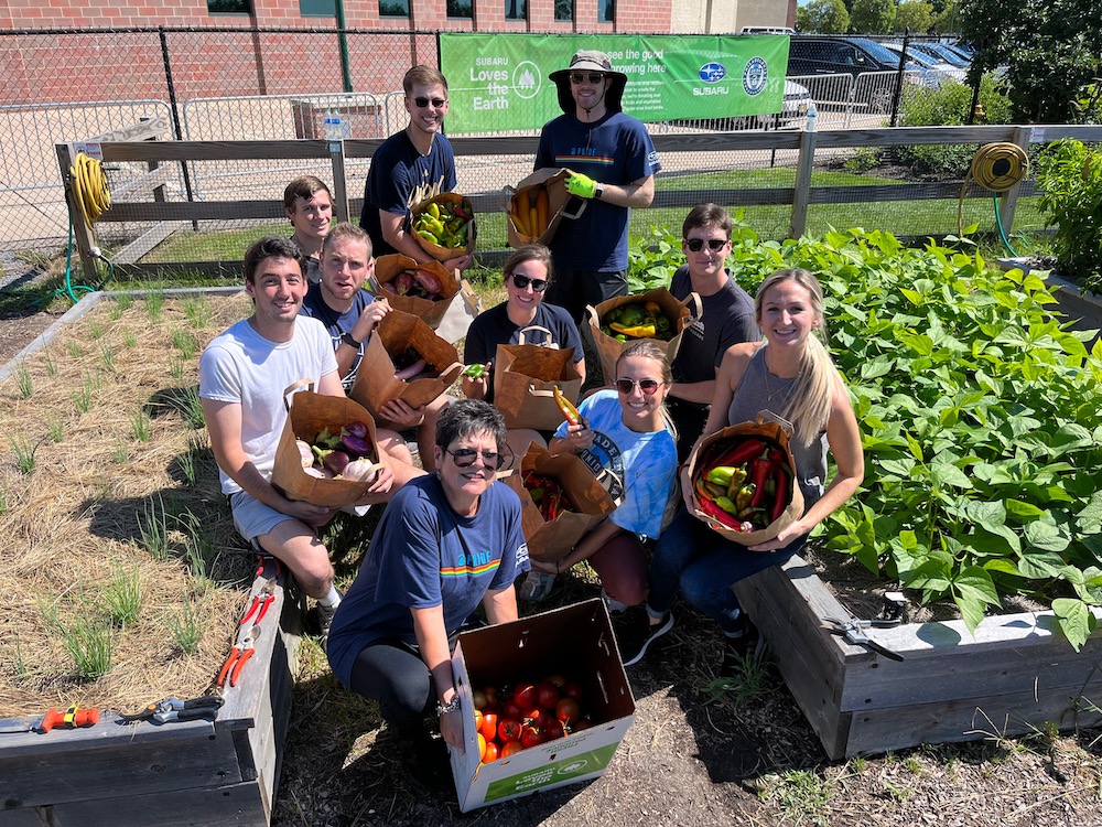 employees and volunteers tend organic community garden at subaru park in chester - home of the philadelphia union