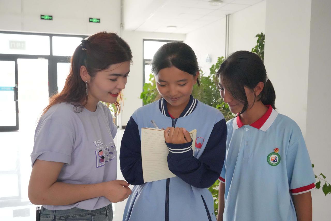 Three students smiling and standing together
