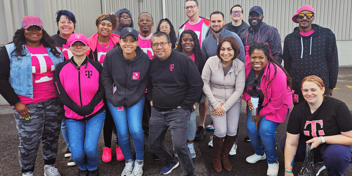 Group of people standing together in T-Mobile branded apparel