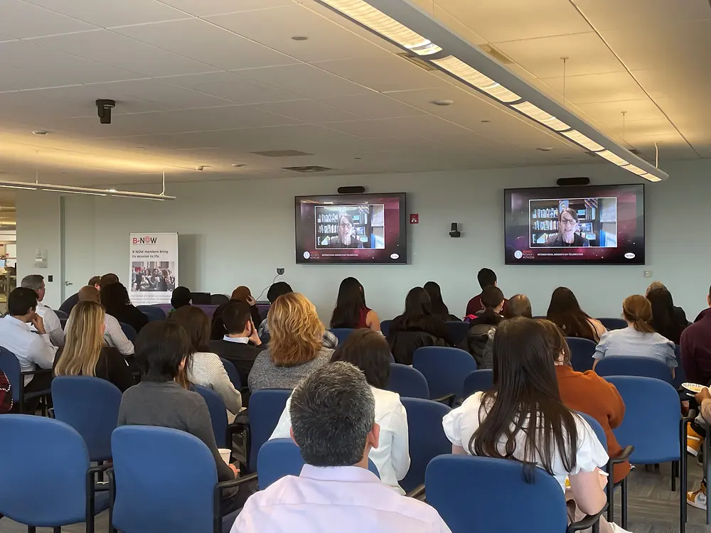 People sitting in chairs watching a presentation