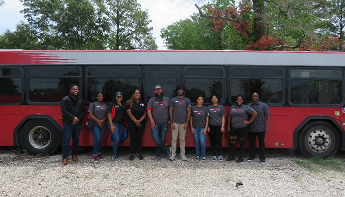 Dow team members standing in front of a bus